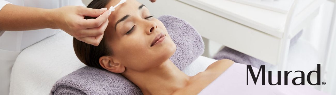 A guest reclining for a facial while an esthetician applies treatment